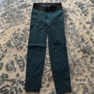 Jade colored Lulu leggings with cutout designs